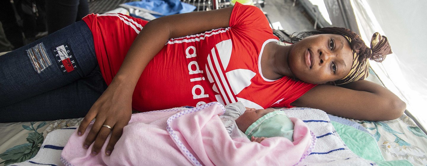 Désir Murielle and her new-born baby boy, Yves, rest in a tented maternity ward. Désir Murielle and her new-born baby boy, Yves, rest in a tented maternity ward.