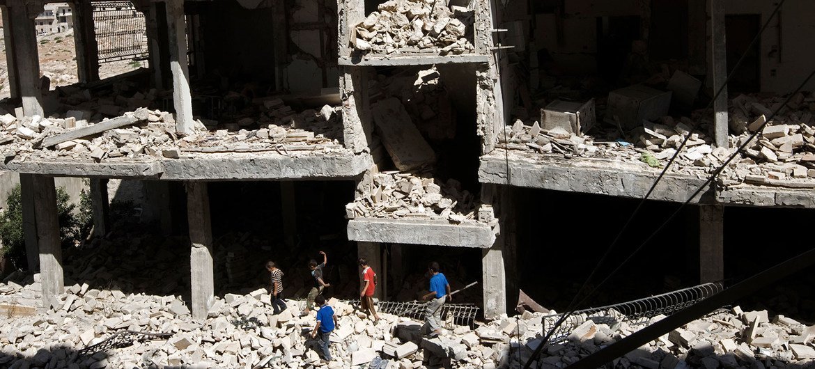 Boys wander amid rubble of destroyed buildings in Idlib, Syria. (file) Boys wander amid rubble of destroyed buildings in Idlib, Syria. (file)