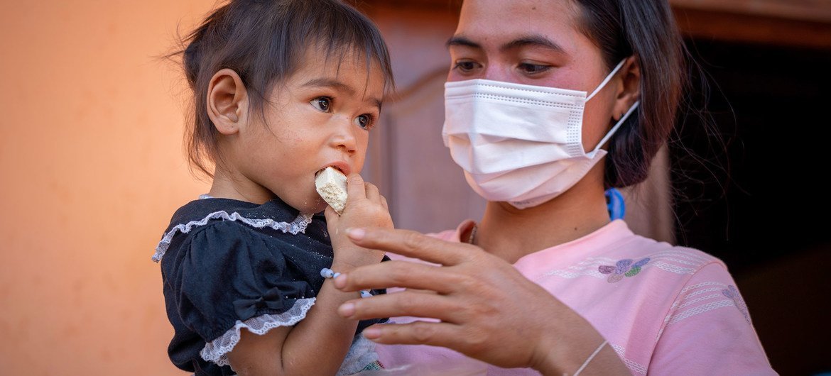 A young girl with her mother at a health centre in Ratanakiri province, Cambodia. A young girl with her mother at a health centre in Ratanakiri province, Cambodia.