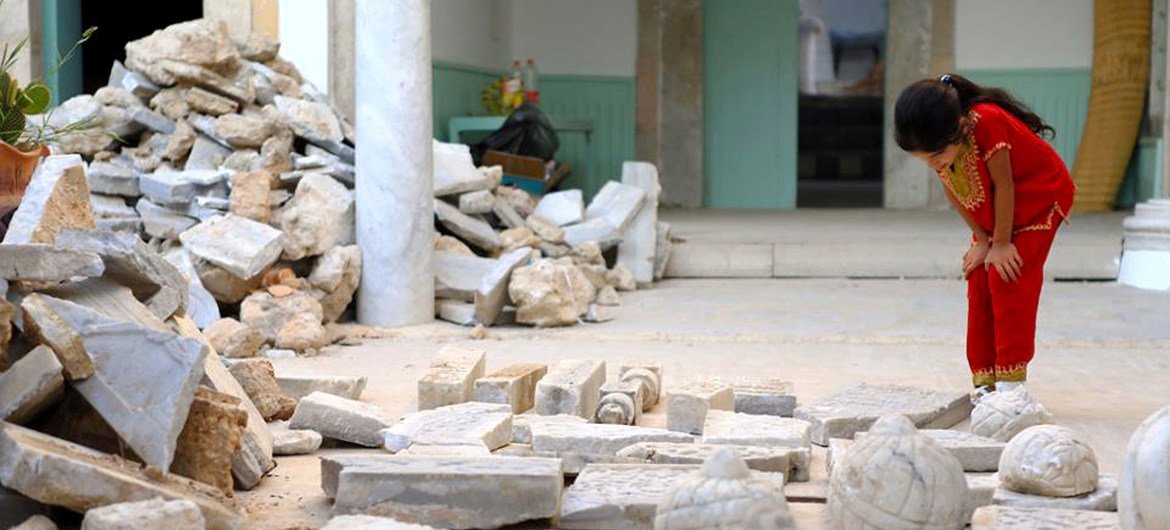 A girl looks at the ruins of the destroyed Othman Basha Sufi seminary in central Tripoli. A girl looks at the ruins of the destroyed Othman Basha Sufi seminary in central Tripoli.