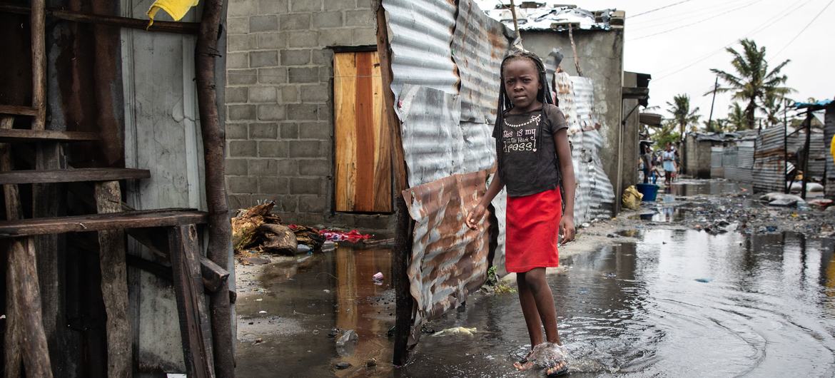 A child in in Beira, Mozambique, stands in rising water after the devastation of Cyclone Idai in 2019. 