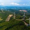 Aerial view of wind turbines installed on green mountains in Quang Tri Province, Vietnam.