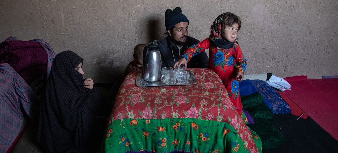 Afganistan'ın Herat kentinde bir aile evde çay içiyor.