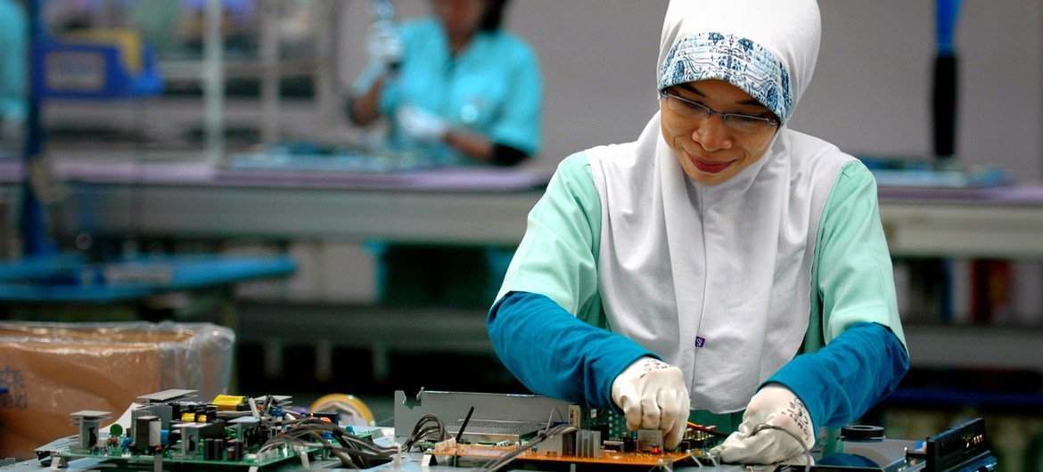 A woman works in an electronics factory in Cikarang, Indonesia. A woman works in an electronics factory in Cikarang, Indonesia.