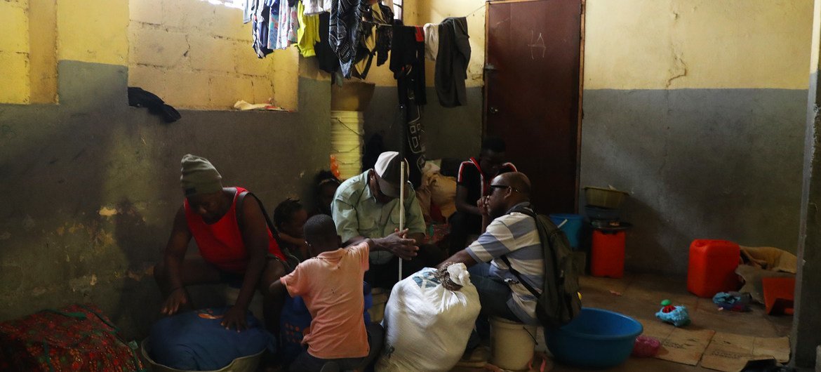 Samuel (centre) and his family wait to leave a temporary site for internally displaced people in Port-au-Prince. Samuel (centre) and his family wait to leave a temporary site for internally displaced people in Port-au-Prince.