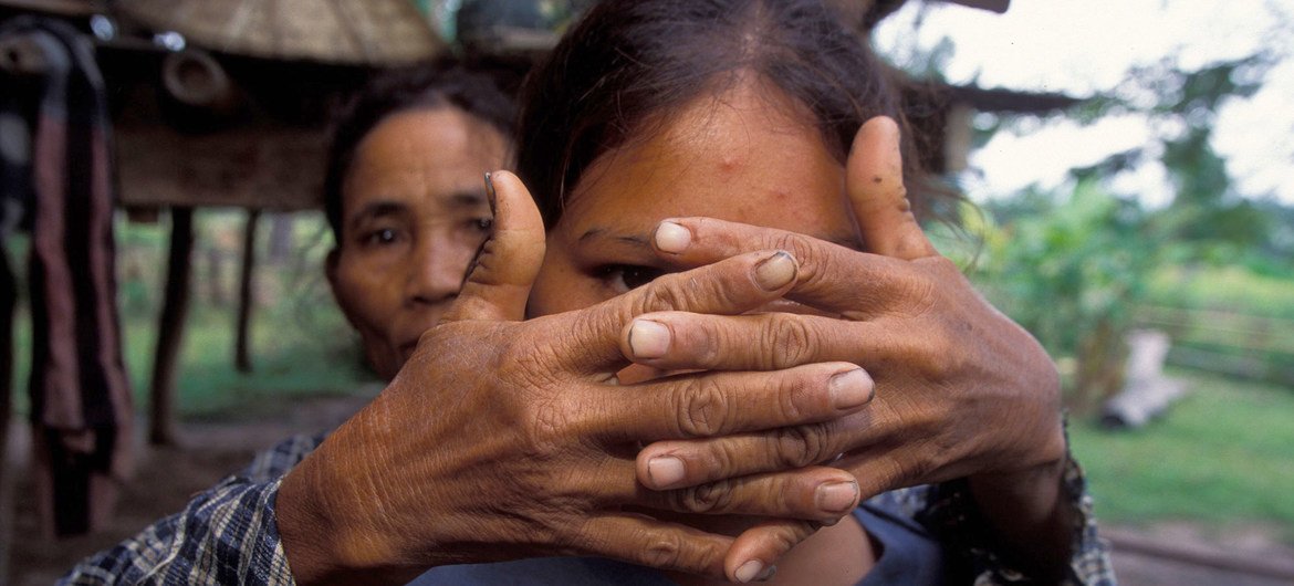 A mother whose daughter was trafficked at the age of sixteen covers her face to protect her identity. A mother whose daughter was trafficked at the age of sixteen covers her face to protect her identity.