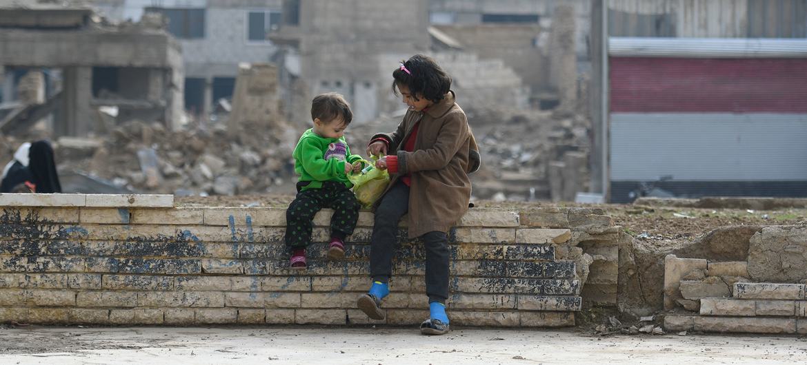 Children sit on a wall in Douma in Syria. Children sit on a wall in Douma in Syria.