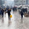 Displaced Palestinians walk through a flooded street at a temporary shelter in Rafah, Gaza Strip, on January 2, 2024.