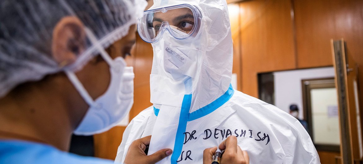 A nurse prepares a physician for the COVID ward at a hospital in New Delhi, India. A nurse prepares a physician for the COVID ward at a hospital in New Delhi, India.