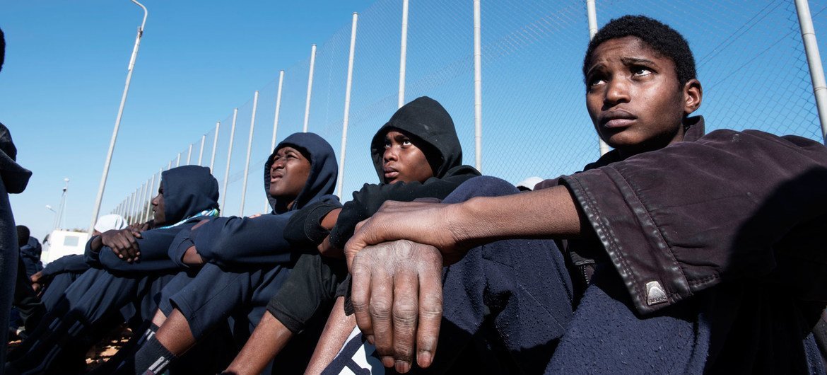Migrants sit in the courtyard of a detention centre in Libya. (file) Migrants sit in the courtyard of a detention centre in Libya. (file)