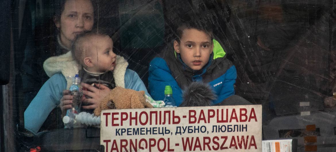 Families arrive in Berdyszcze, Poland, after crossing the border from Ukraine, fleeing escalating conflict.