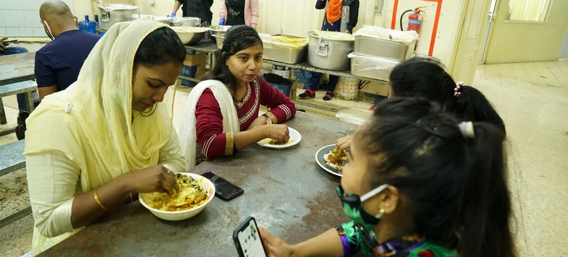 Maya Aktar eating with migrant workers. Maya Aktar eating with migrant workers.