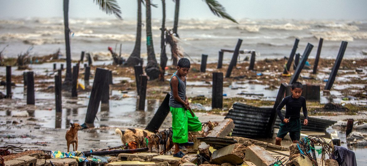 Children search for scraps of wood to help their parents rebuild their house after it was destroyed by the strong winds of Hurricane Iota in Nicaragua.