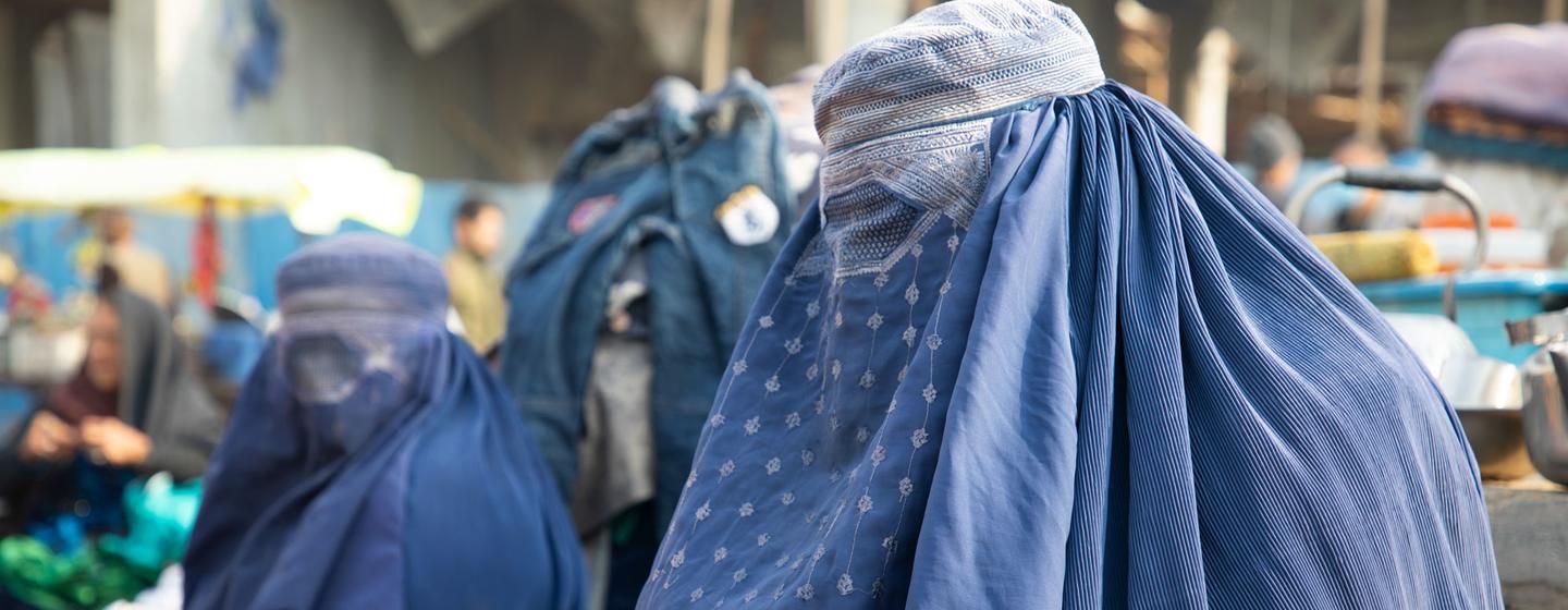 Women selling their belongings in a market in Balkh province, Afghanistan. Women selling their belongings in a market in Balkh province, Afghanistan.