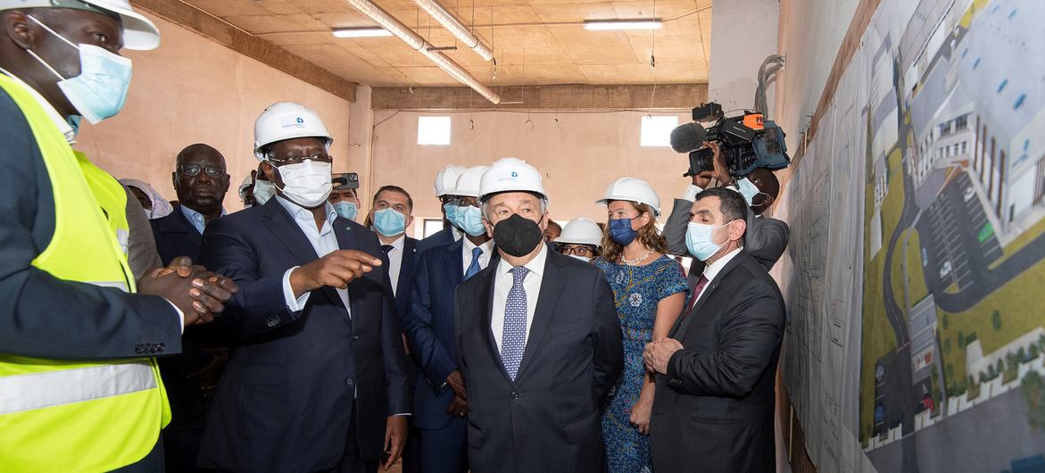 UN Secretary-General António Guterres (centre) tours a vaccine production facility at the Institut Pasteur in Dakar, with the President of Senegal, Macky Sall (left centre). UN Secretary-General António Guterres (centre) tours a vaccine production facility at the Institut Pasteur in Dakar, with the President of Senegal, Macky Sall (left centre).