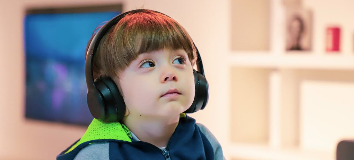 A boy listens to music with headphones in Tehran, Iran A boy listens to music with headphones in Tehran, Iran