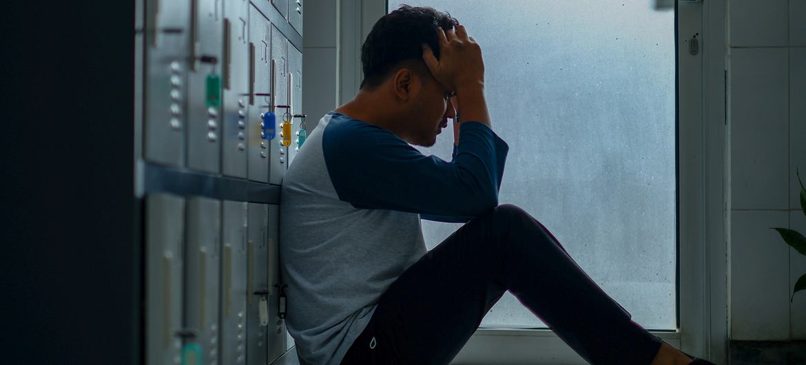 A pensive young man, sits in a locker room. A pensive young man, sits in a locker room.
