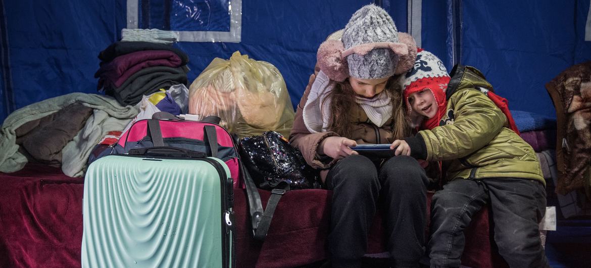 A nine-year-old girl and her three-year-old brother arrive at a temporary shelter in Romania after fleeing the conflict in Ukraine with their mother. A nine-year-old girl and her three-year-old brother arrive at a temporary shelter in Romania after fleeing the conflict in Ukraine with their mother.