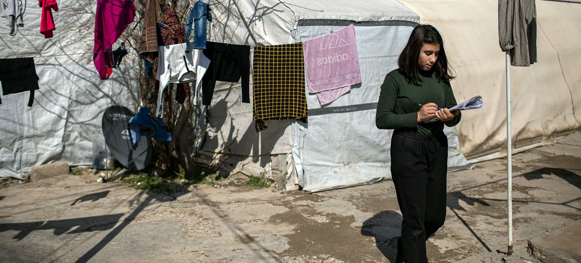 A 14-year-old Yazidi girl prepares for an exam in the Shekhan camp for internally displaced persons. A 14-year-old Yazidi girl prepares for an exam in the Shekhan camp for internally displaced persons.
