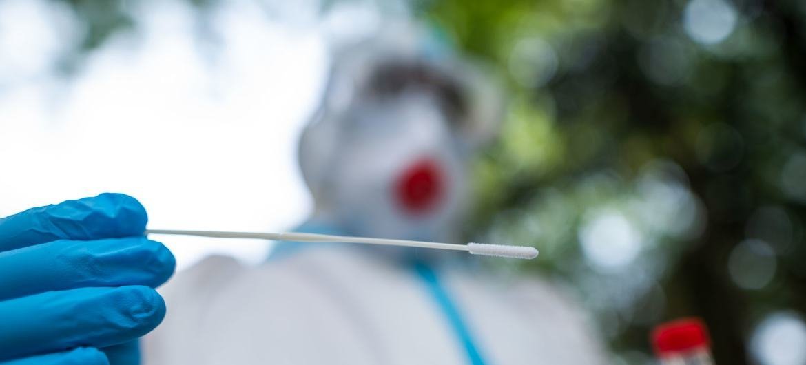 A lab technician collects a sample of a patient for covid testing in New Delhi, India. A lab technician collects a sample of a patient for covid testing in New Delhi, India.