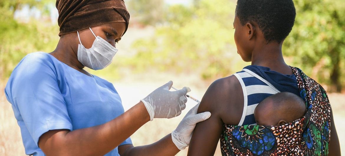 A woman is getting vaccinated in Kasungo District, Malawi A woman is getting vaccinated in Kasungo District, Malawi