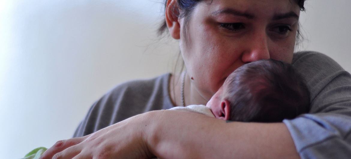 A mother holds her newborn baby at a hospital in Kyiv, Ukraine. A mother holds her newborn baby at a hospital in Kyiv, Ukraine.