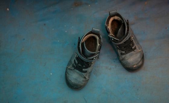 A boy's shoes are displayed at the Red Cross tent for mothers and children at Lviv train station, Ukraine.