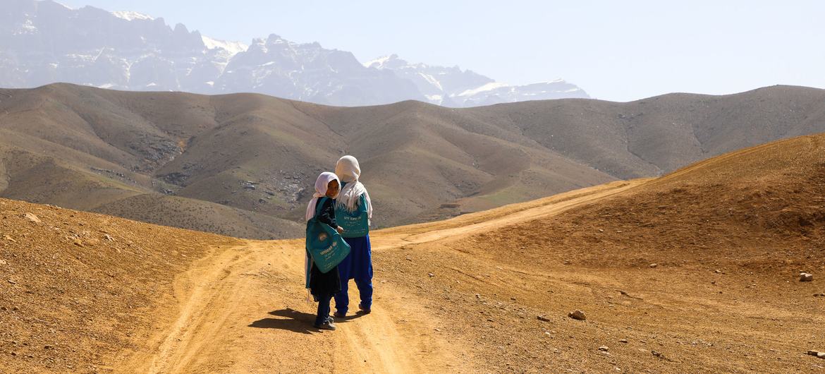 Students of the Warkak's accelerated learning center in Daikundi Province, Afghanistan, walk home together over the dusty hills. Students of the Warkak's accelerated learning center in Daikundi Province, Afghanistan, walk home together over the dusty hills.