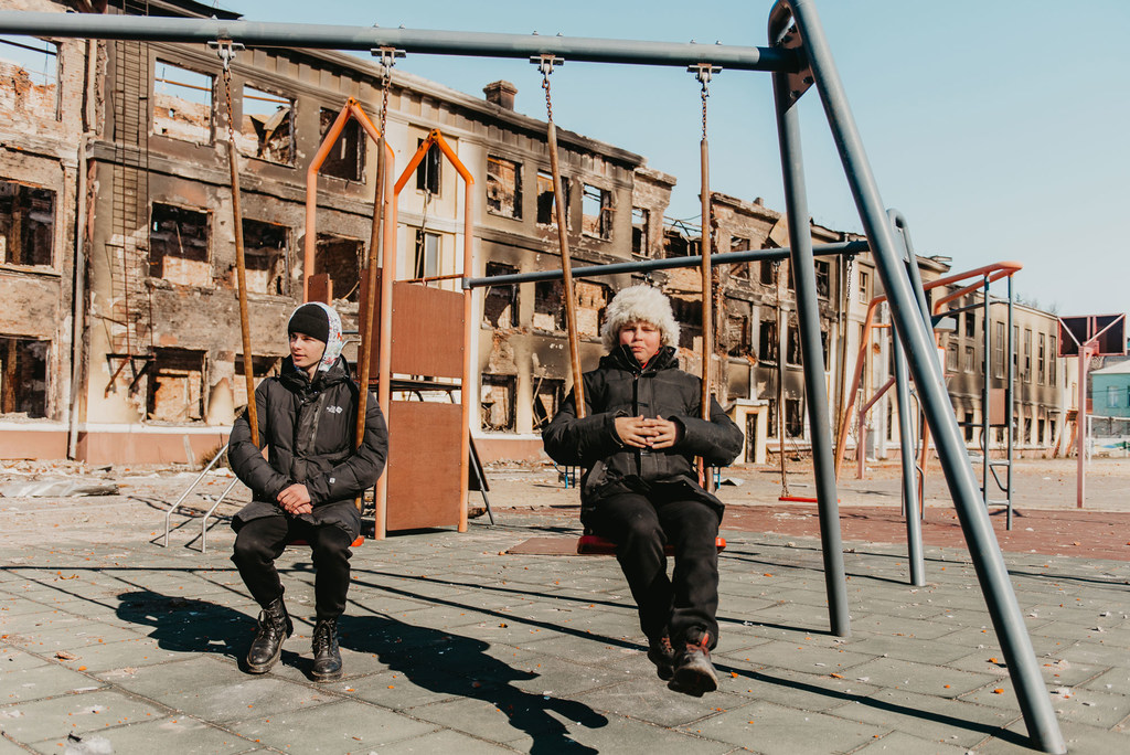 Two 14-year-olds play on the swings at their former school in Kharkiv, northeast Ukraine, after it was destroyed by shelling. Two 14-year-olds play on the swings at their former school in Kharkiv, northeast Ukraine, after it was destroyed by shelling.