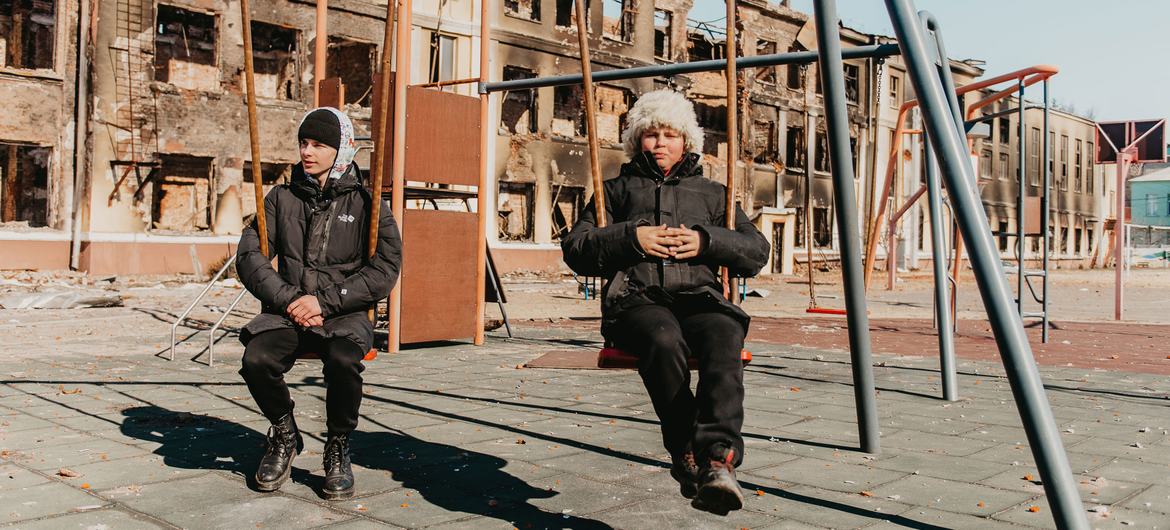Two 14-year-olds play on the swings at their former school in Kharkiv, northeast Ukraine, after it was destroyed by shelling. Two 14-year-olds play on the swings at their former school in Kharkiv, northeast Ukraine, after it was destroyed by shelling.