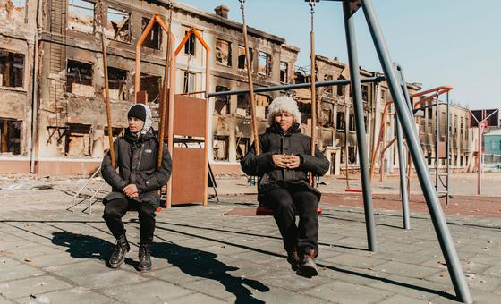 Two 14-year-old students play on a swing at their old school in Kharkiv, northeastern Ukraine, after it was destroyed by shelling.