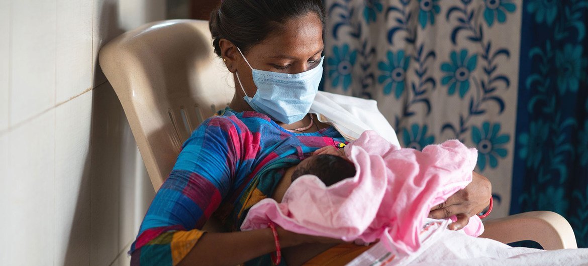 A woman breastfeeds her baby in a labour room in India shortly after giving birth. A woman breastfeeds her baby in a labour room in India shortly after giving birth.