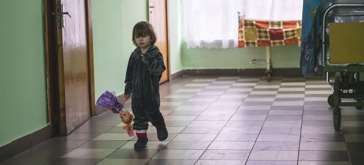 A small child, displaced from an orphanage in the Kharkiv region, walks in the hall of a shelter located in a sanatorium in Vorokhta, western Ukraine. A small child, displaced from an orphanage in the Kharkiv region, walks in the hall of a shelter located in a sanatorium in Vorokhta, western Ukraine.