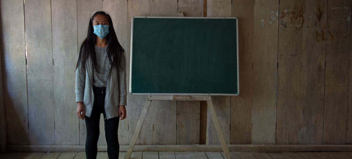 A seventeen-year-old girl stands in her classroom at school in Nagaland, India. A seventeen-year-old girl stands in her classroom at school in Nagaland, India.