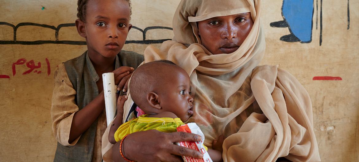 Children in Sudan receive a peanut-based paste for treatment of malnutrition. Children in Sudan receive a peanut-based paste for treatment of malnutrition.