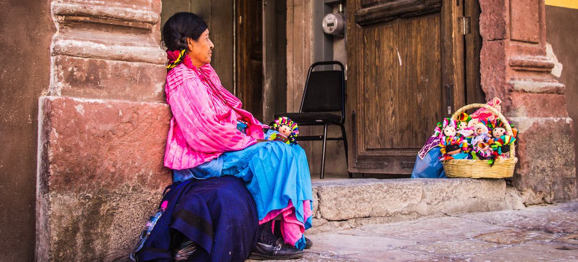 A indigenous mexican woman selling dolls in the streets of Santiago de Queretaro, Mexico. A indigenous mexican woman selling dolls in the streets of Santiago de Queretaro, Mexico.