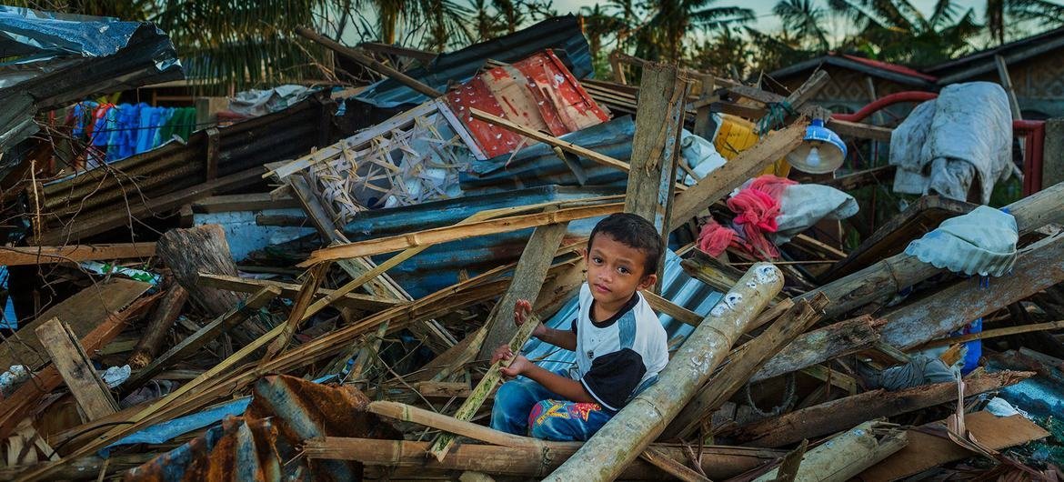 A boy sits in the debris of homes destroyed by Typhoon Rai in the Purok district of the Philippines. A boy sits in the debris of homes destroyed by Typhoon Rai in the Purok district of the Philippines.