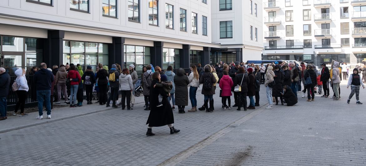 Refugees from Ukraine wait to register for cash assistance in Warsaw, Poland.
