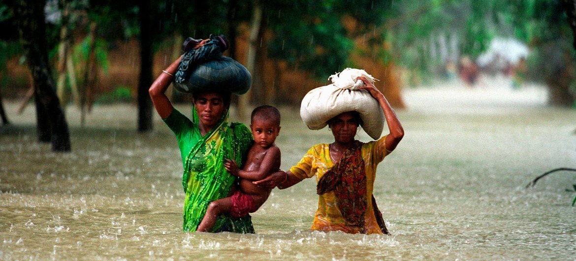 People wade through water during floods in the Kurigram district of Bangladesh. People wade through water during floods in the Kurigram district of Bangladesh.