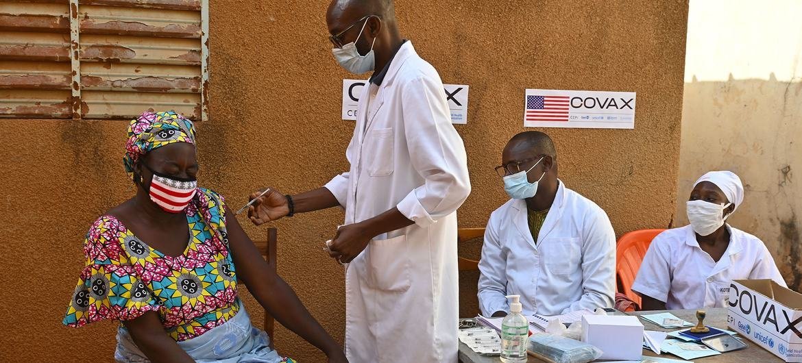 A mother receives a second dose of COVID-19 vaccine at a medical center in Obassin, Burkina Faso.