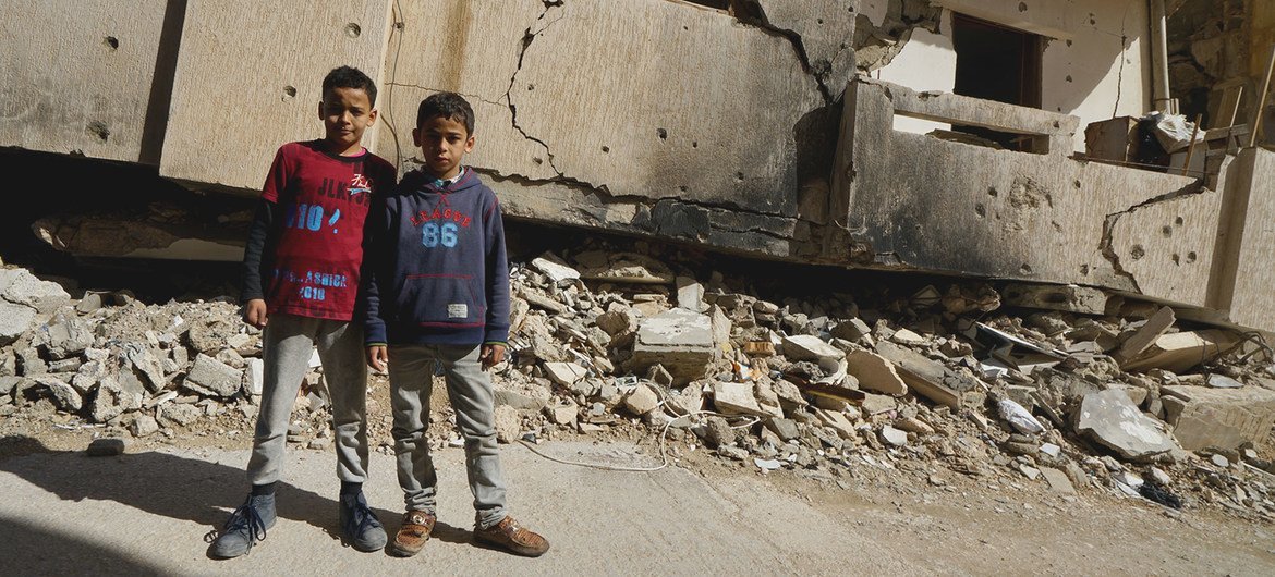 Young boys stand in front of a destroyed building in Benghazi Old Town in Libya. (file) Young boys stand in front of a destroyed building in Benghazi Old Town in Libya. (file)