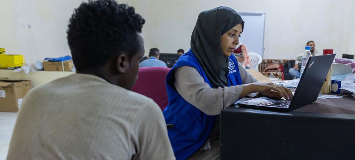 An IOM staff member registers an Ethiopian migrant in Ma’rib, Yemen, prior to travel to Addis Ababa. An IOM staff member registers an Ethiopian migrant in Ma’rib, Yemen, prior to travel to Addis Ababa.