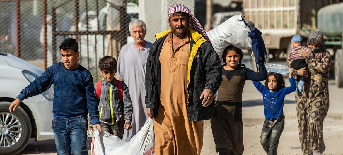 Families fleeing escalating violence in northeast Syria. Families fleeing escalating violence in northeast Syria.