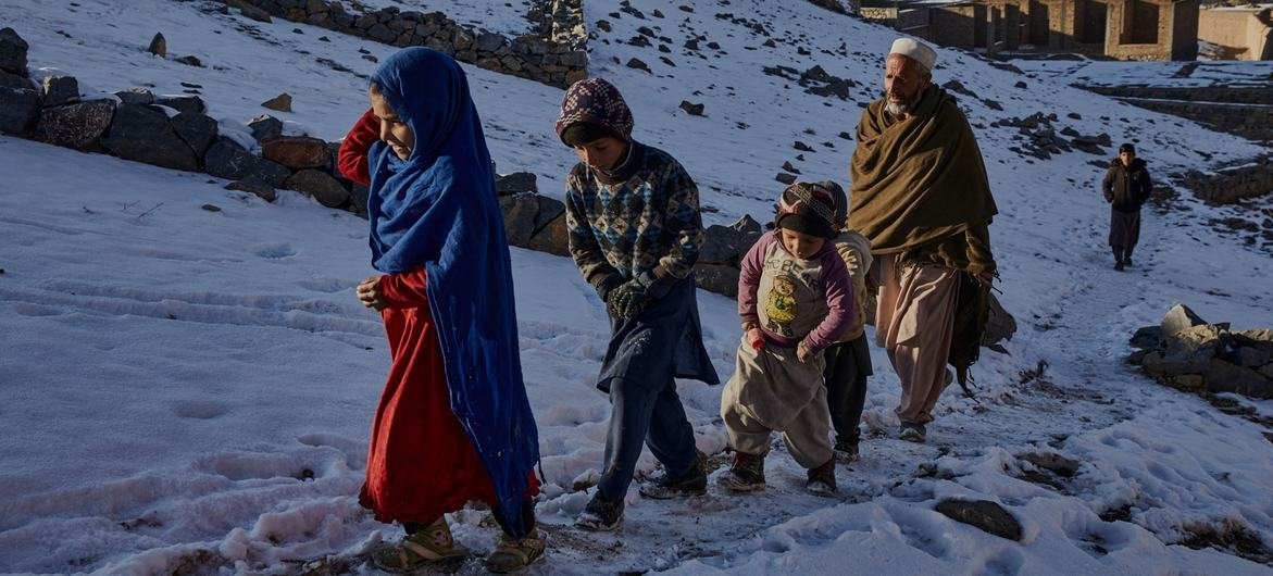 Displaced families collect water during a harsh winter in Kabul, Afghanistan. Displaced families collect water during a harsh winter in Kabul, Afghanistan.