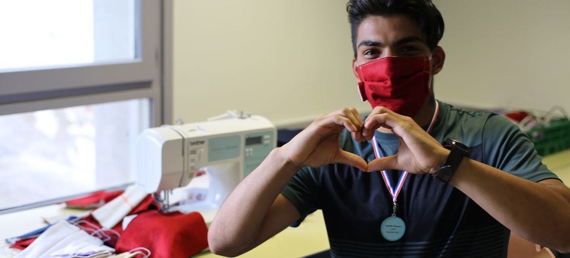 A 23-year-old Afghan refugee has stitched over 700 protective masks during the COVID-19 crisis to help support his new community in France. A 23-year-old Afghan refugee has stitched over 700 protective masks during the COVID-19 crisis to help support his new community in France.