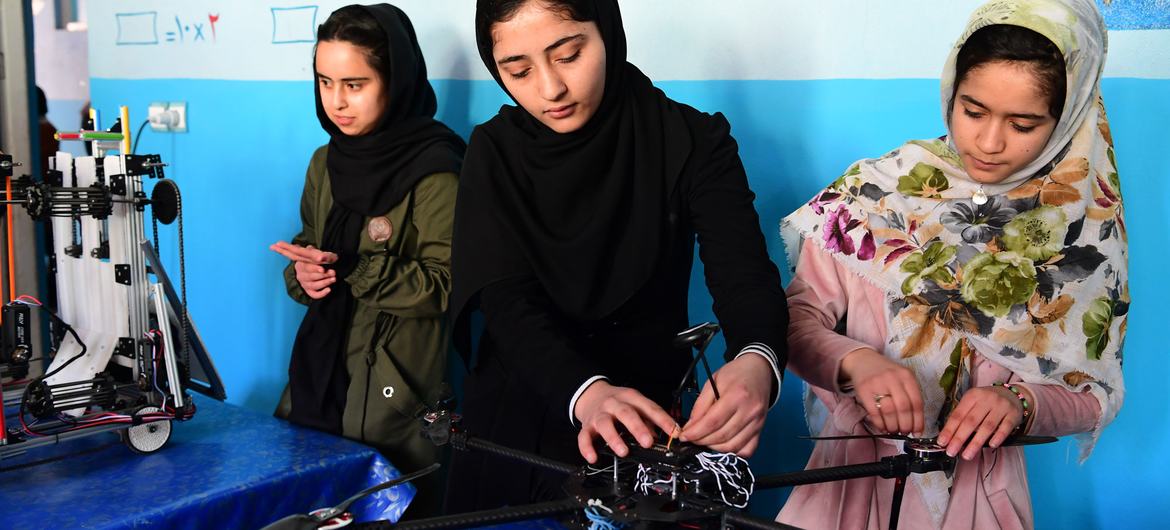 Young girls work on a robotics project in Afghanistan. Young girls work on a robotics project in Afghanistan.
