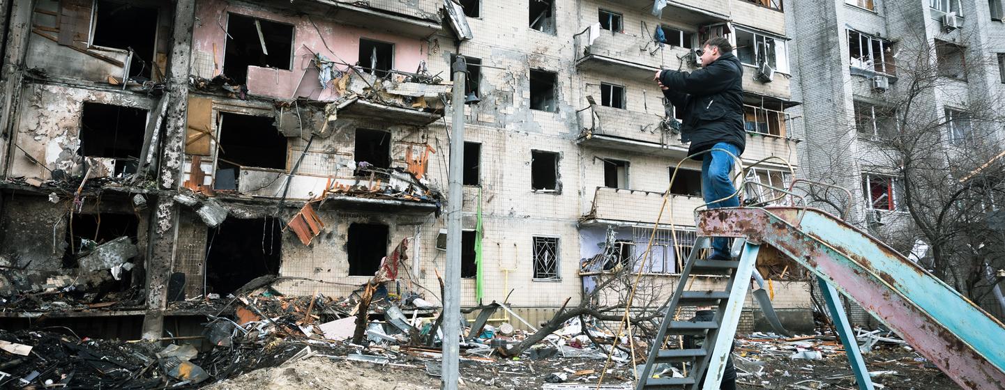 A man photographs an apartment building that was heavily damaged during escalating conflict, in Kyiv, Ukraine. A man photographs an apartment building that was heavily damaged during escalating conflict, in Kyiv, Ukraine.