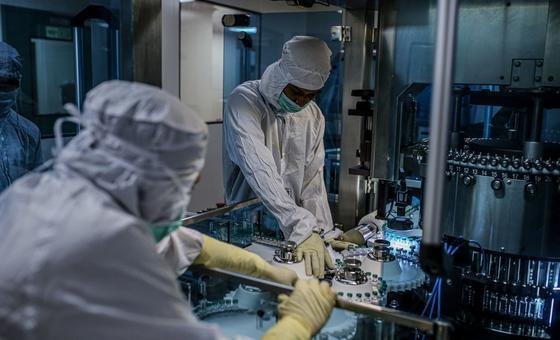 Employees work on the production line of a COVID-19 vaccine in India. Employees work on the production line of a COVID-19 vaccine in India.
