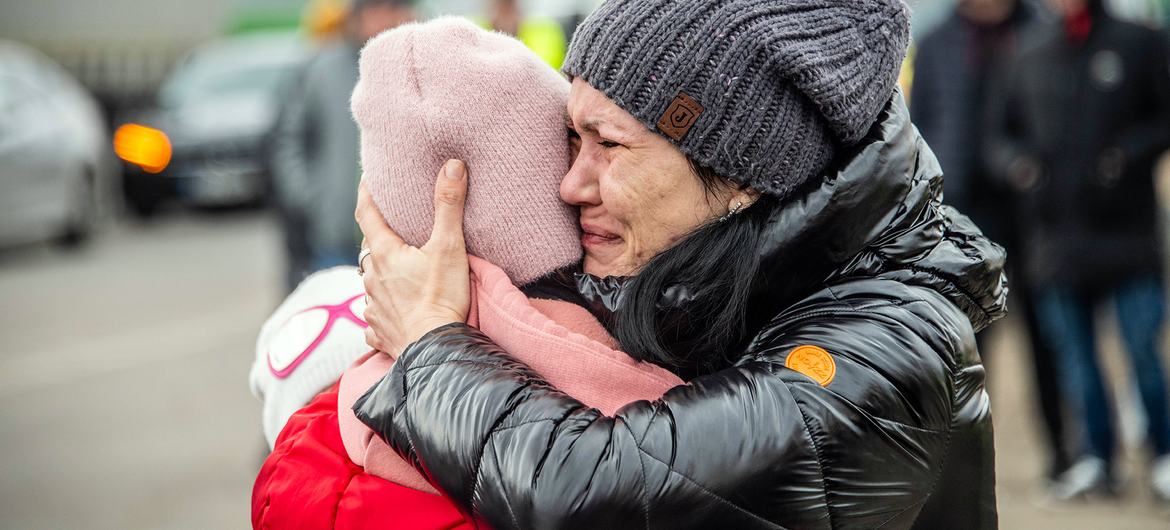 A woman holds her child as she arrives in Berdyszcze in Poland, after crossing the border from Ukraine. A woman holds her child as she arrives in Berdyszcze in Poland, after crossing the border from Ukraine.