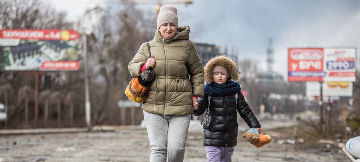 A mother and daughter flee violence in Bucha, Kyiv Oblast, Ukraine. A mother and daughter flee violence in Bucha, Kyiv Oblast, Ukraine.